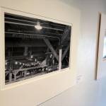 A photograph entitled CWF Rafters by Patrick Dixon hangs on the wall of the Kenai Fine Art Center Thursday, June 6, 2019, during the opening reception to the June exhibit Historic Buildings of Kenai. (Photo by Joey Klecka/Peninsula Clarion)