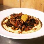 Red wine-braised veggies and smoked carrots over grits with pickled mustard seeds are pictured. The dish is just one of the many vegan and gluten-free items diners might find at Kingfisher Roadhouse, in Cooper Landing, Alaska. (Photo courtesy of Katherine OLeary-Cole)