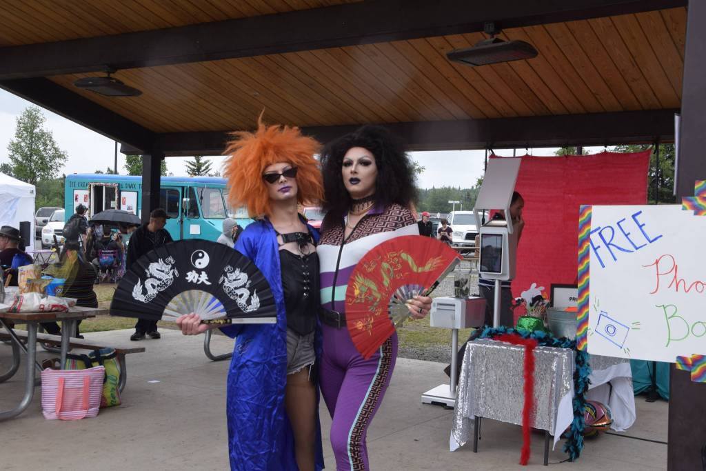 Salmon Chowder, left, and Mrs. Sativa, right, pose for the camera during the 2019 Soldotna Pride Celebration in Soldotna Creek Park on Saturday, June 15, 2019. (Photo by Brian Mazurek/Peninsula Clarion)