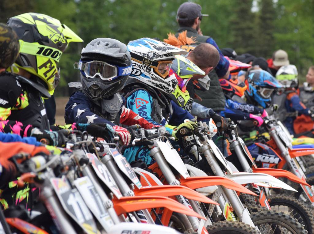 Young riders in the 65cc class prepare to take off for the start Saturday, June 15, 2019, at the Alaska State Motocross Championships at Twin City Raceways motocross track in Kenai, Alaska. (Photo by Joey Klecka/Peninsula Clarion)