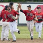 Oilers outfielders Calvin Farris, Camden Vasquez and Paul Steffensen receive congratulations after the Oilers defeated the Chugiak-Eagle River Chinooks on Sunday, June 16, 2019, at Coral Seymour Memorial Park in Kenai, Alaska.