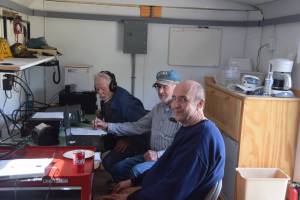 From left, George Van Lone, Max Carpenter and Ed Seaward monitor the airwaves inside the Moose Horn Amateur Radio Clubs mobile operation center in Kenai, Alaska during the Amateur Radio Relay Leagues annual Field Day on June 22, 2019. (Photo by Brian Mazurek/Peninsula Clarion)