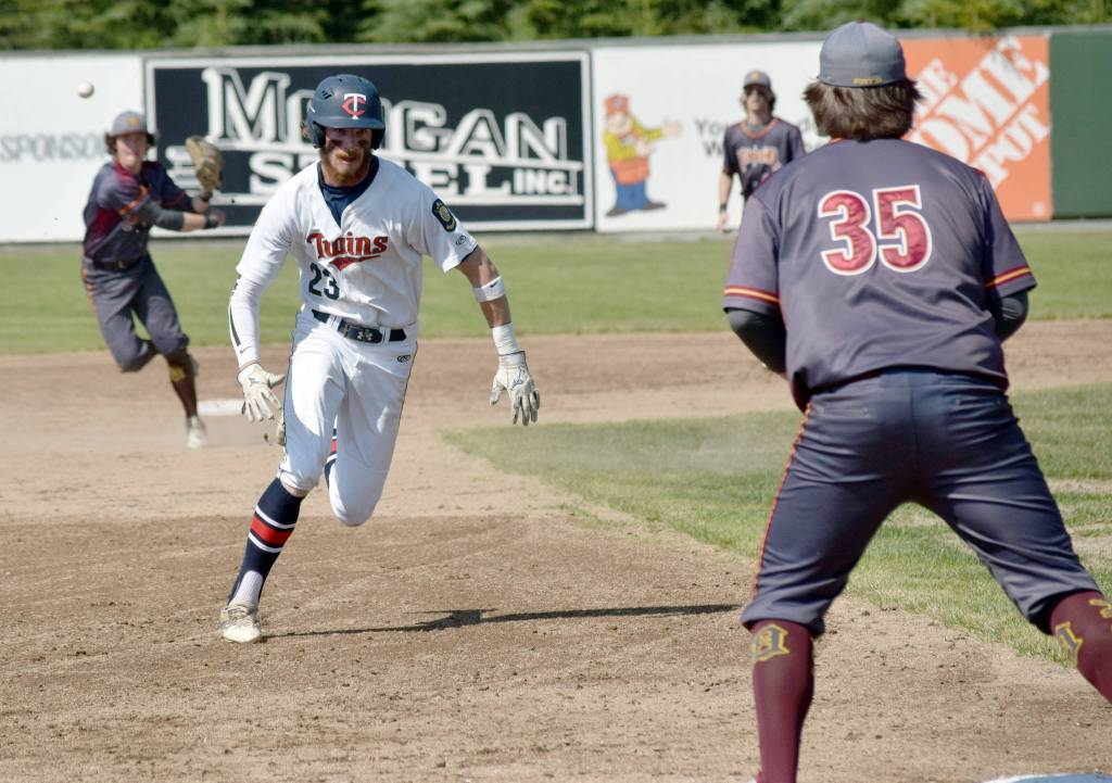 David Michael of the Post 20 Twins scrambles to third to beat the throw of Dimond shortstop Mathew Thompson on Sunday, June 23, 2019, at Coral Seymour Memorial Park in Kenai, Alaska. Third baseman Parker Coplin awaits the throw. (Photo by Jeff Helminiak/Peninsula Clarion)