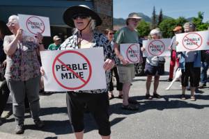 Judy Cavanaugh stands with others at a rally against the Pebble Mine in front of Sen. Lisa Murkowskis Juneau office on Tuesday. (Michael Penn | Juneau Empire)