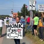 Residents line the Sterling Highway, in front of Sen. Lisa Murkowskis office to oppose Pebble mine on Wednesday, June 26, 2019, in Soldotna, Alaska. (Photo by Victoria Petersen/Peninsula Clarion)