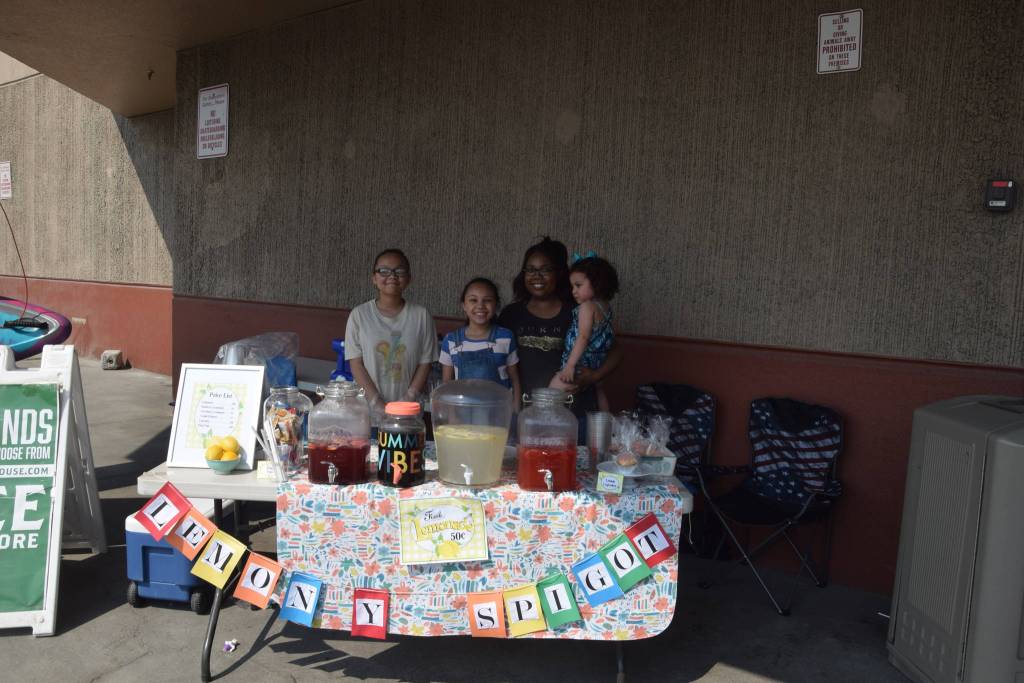 From left, Addison, Isabella, Bri and Emma Havrilla smile for the camera at their lemonade stand outside of Sportsmans Warehouse during Lemonade Day in Soldotna, Alaska on June 29, 2019. (Photo by Brian Mazurek/Peninsula Clarion)