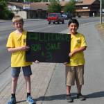 Tucker Challans, left, and Logan Amaya, right, advertise their lemonade business along the Kenai Spur Highway during Lemonade Day in Soldotna, Alaska on June 29, 2019. (Photo by Brian Mazurek/Peninsula Clarion)