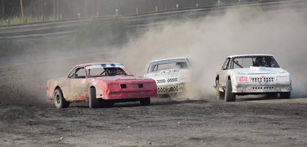 Nikiskis Mady Stichal (left) races Dustin Bass off a corner Saturday, June 29, 2019, in an A-Stock heat race at Twin Cities Raceway in Kenai, Alaska. (Photo by Joey Klecka/Peninsula Clarion)