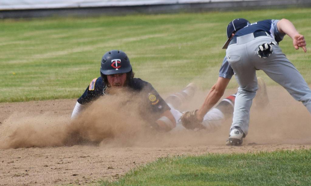 The Twins David Michael safely slides into second base ahead of the tag of Eagle Rivers Devin Wilcox (right) Tuesday at the Bill Miller Big Fish Wood Bat Tournament at Coral Seymour Memorial Park in Kenai. (Photo by Joey Klecka/Peninsula Clarion