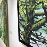Mossy Tree at Williwaw, an acrylic painting by Chelline Larsen, hangs Tuesday at the Kenai Fine Art Center in Kenai. (Photo by Joey Klecka/Peninsula Clarion)
