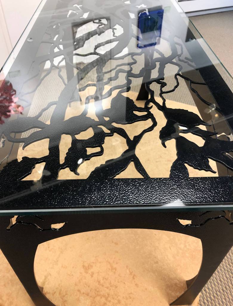 Birch Branch Table, a steel and glass designed table by Chelline Larsen and Adam Hoyt sits in the gallery Tuesday at the Kenai Fine Art Center in Kenai. (Photo by Joey Klecka/Peninsula Clarion)