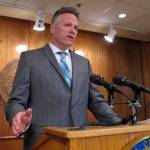 Gov. Mike Dunleavy speaks to reporters about his budget vetoes at the state Capitol in Juneau on Friday. (AP Photo/Becky Bohrer)