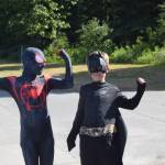 Spiderman and Batman flex their muscles during the July 4th parade in Kenai, Alaska. (Photo by Brian Mazurek/Peninsula Clarion)