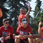 Members of the Peninsula Oilers baseball team wave to the crowd during the July 4th parade in Kenai, Alaska. (Photo by Brian Mazurek/Peninsula Clarion)