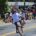 Kids show off their unicycle skills during the July 4th parade in Kenai, Alaska. (Photo by Brian Mazurek/Peninsula Clarion)