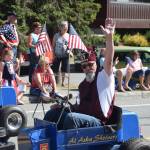 One of the Alaska Shriners waves to the crowd during the July 4th parade in Kenai, Alaska. (Photo by Brian Mazurek/Peninsula Clarion)