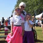 Dorothy Gray and her granddaughters Leah and Eileen Arness smile for the camera at the Kenai Park Strip during the July 4th parade in Kenai, Alaska. (Photo by Brian Mazurek/Peninsula Clarion)