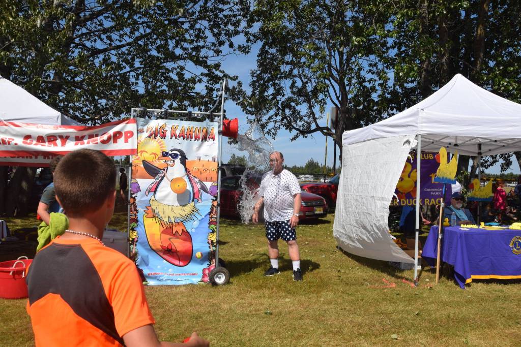 Rep. Gary Knopp – R, Soldotna, gets soaked at his dunk tank at the Kenai Park Strip during the July 4th parade in Kenai, Alaska. (Photo by Brian Mazurek/Peninsula Clarion)