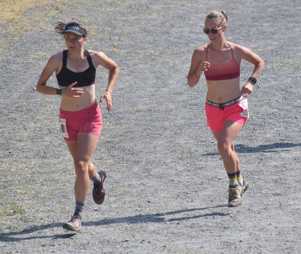 Abby Jahn of Anchorage and Allison Barnwell of Seward approach the mountain during the womens Mount Marathon Race on Thursday, July 4, 2019, in Seward, Alaska. (Photo by Jeff Helminiak/Peninsula Clarion)
