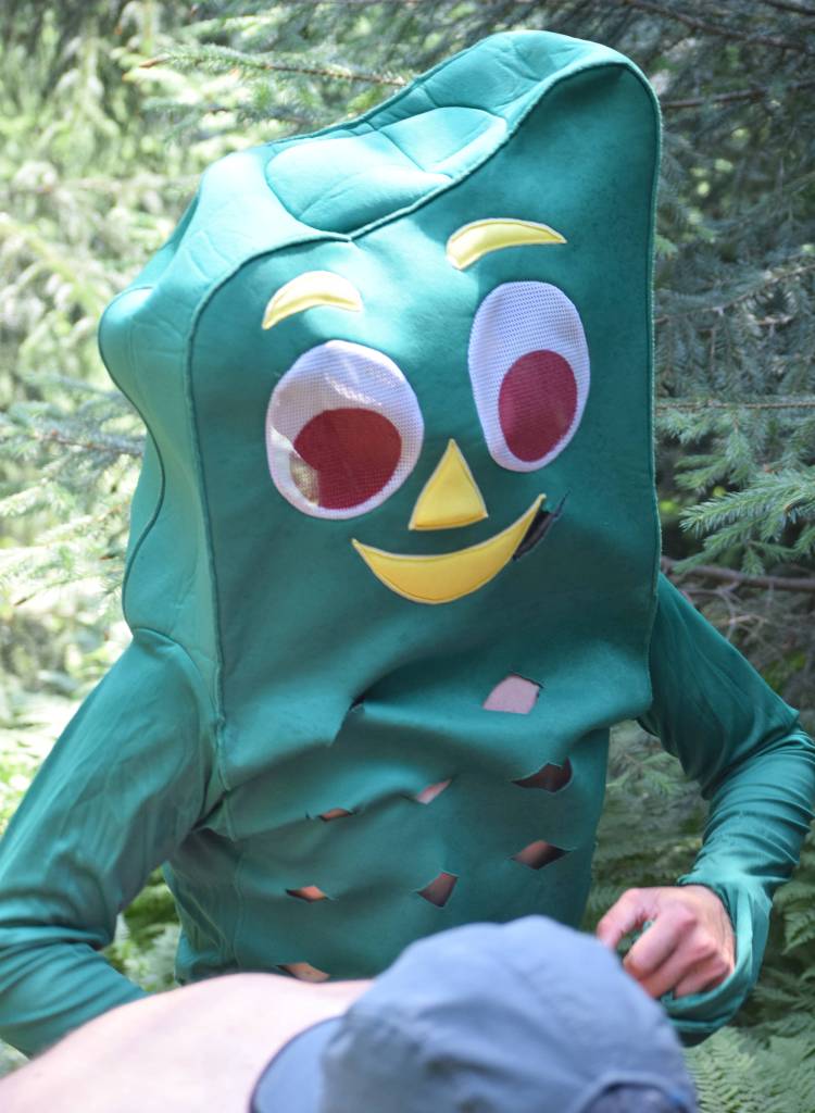 Sewards Joe Nyholm plows throught the hot foliage dressed as Gumby during the mens Mount Marathon Race on Thursday, July 4, 2019, in Seward, Alaska. (Photo by Jeff Helminiak/Peninsula Clarion)