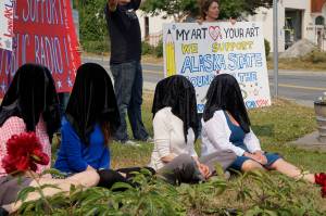 Photo by Michael Armstrong / Homer News                                Women draped in black sit down Tuesday at WKFL Park in Homer as part of a statewide art intervention to protest Gov. Mike Dunleavys veto of a $2.8 million state appropriation to the Alaska State Council on the Arts. They also supported a general override of Dunleavys vetoes that will affect funding for the University of Alaska, public radio and other programs.