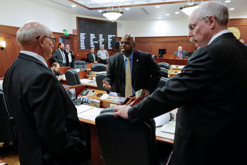Sen. David Wilson, R-Wasilla, center, has a heated discussion with Sen. John Coghill, North Pole, left, as Sen. Bert Stedman, R-Sitka, listens before a Joint Session of Alaska Legislature at the Capitol on Thursday, July 11, 2019, to debate and vote on an override of Gov. Mike Dunleavys budget vetoes. The vote didnt take place because not enough legislators attended. (Michael Penn | Juneau Empire)
