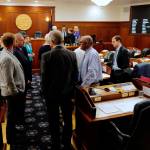 Lawmakers talk among themselves during a break of a joint session of the Alaska Legislature Thursday, July 11, 2019, in Juneau, Alaska. Lawmakers are meeting for a second day to consider overriding Gov. Mike Dunleavys budget vetoes, but still dont have the needed 45 votes as about a third of lawmakers continue to meet in Wasilla instead of Juneau. (Michael Penn/The Juneau Empire via AP)