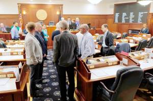 Michael Penn/The Juneau Empire                                Lawmakers talk among themselves during a break of a joint session of the Alaska Legislature on Thursday in Juneau.