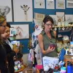 Localz owner Angel Stanton, right, shows Heidi Vann, left, and Denali Jackson, center, some of the products featured in her store on July 11, 2019 in Nikiski, Alaska. (Photo by Brian Mazurek/Peninsula Clarion)