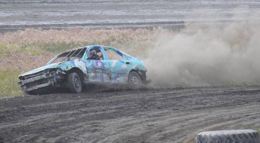 Kinsie Schultz drops the right-side tires of the No. 19 Dollar Stock car off the racing surface Saturday, July 13, 2019, at Twin City Raceway in Kenai, Alaska. (Photo by Joey Klecka/Peninsula Clarion)