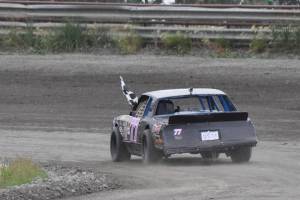 Powder Puff winner Brenda Robson drives a victory lap with the checkered flag Saturday, July 13, 2019, at Twin City Raceway in Kenai, Alaska. (Photo by Joey Klecka/Peninsula Clarion)