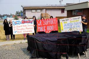 People draped in black hold signs on July 9, 2019, by Sean Derrys public art sculpture in Homer, Alaska, as part of a statewide art intervention to protest Gov. Mike Dunleavys veto of a $2.8 million state appropriation to the Alaska State Council on the Arts. They also supported a general override of Dunleavys vetoes that will affect funding for the University of Alaska, public radio and other programs. Derrys sculpture was commissioned as a 1% for art project associated with the remodeling of Pioneer Hall at the Kachemak Bay Campus, Kenai Peninsula College, University of Alaska. The protest was not sanctioned by the college. (Photo by Michael Armstrong/Homer News)