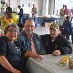 From left, Terry Carter, Dave Unruh, and Dan Gregory smile for the camera at Fire Station #2 during the Nikiski Fire Departments 50th anniversary celebration in Nikiski, Alaska on July 15, 2019. Carter has been the front desk receptionist for the department for 30 years. Unruh is a retired captain and was the second person employed by the department, and Gregory was was fire chief from 2000 to 2005. (Photo by Brian Mazurek/Peninsula Clarion)