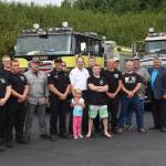 Current and former personnel for the Nikiski Fire Department smile for the camera at Fire Station #2 during the departments 50th anniversary celebration in Nikiski, Alaska on July 15, 2019. (Photo by Brian Mazurek/Peninsula Clarion)
