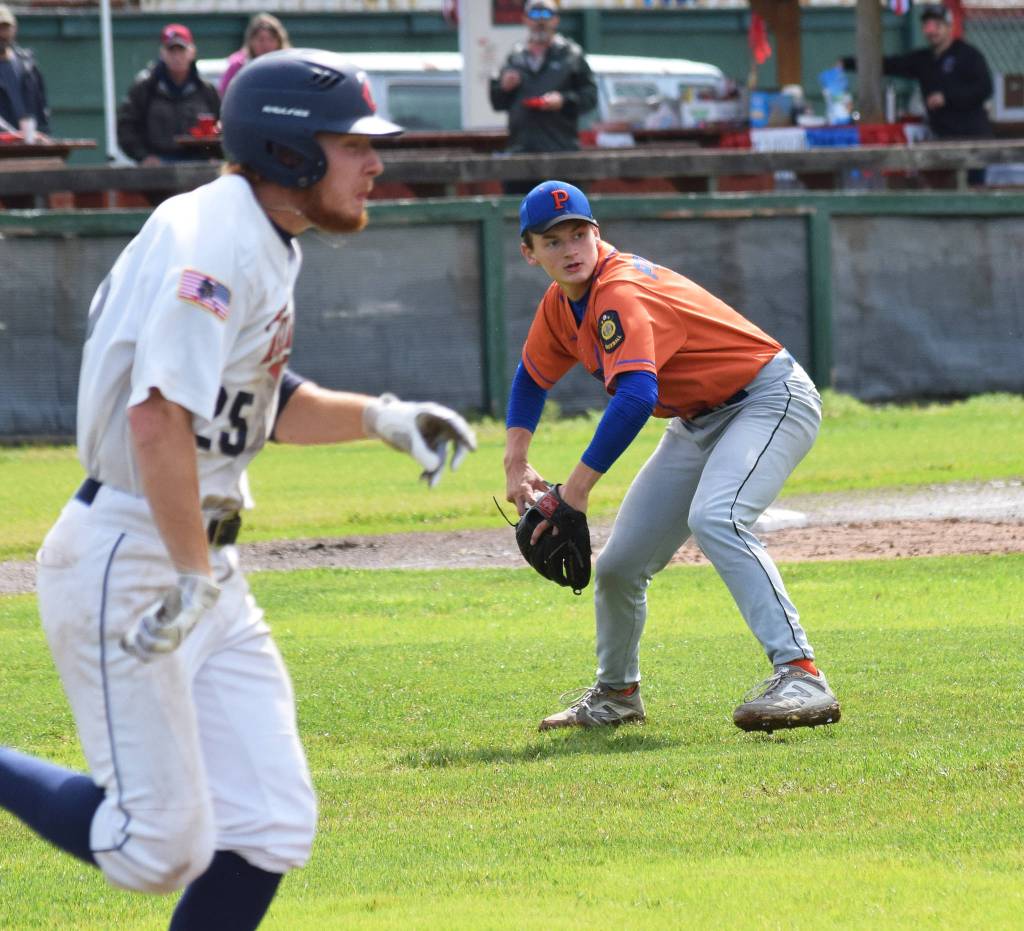 Palmer pitcher Ben Alley (right) fields a grounder by the Twins Jeremy Kupferschmid Tuesday, July 16, 2019, at Coral Seymour Memorial Park in Kenai, Alaska. (Photo by Joey Klecka/Peninsula Clarion)