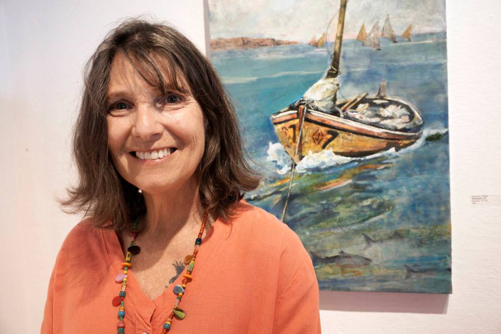 Photo by Michael Armstrong/Homer News                                Antoinette Walker poses by one of her encaustic paintings, Diamond #7, at the First Friday opening of her exhibit on July 5, 2019, at Bunnell Street Arts Center in Homer, Alaska.