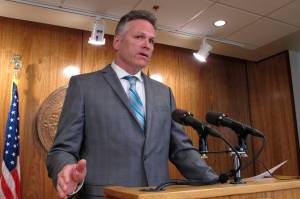 Gov. Mike Dunleavy speaks to reporters about his budget vetoes at the state Capitol in Juneau, June 28. (AP Photo/Becky Bohrer)