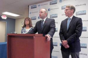 Joshua Decker, center, director of the ACLU of Alaska, speaks at a press conference with Bonnie Jack, left, and John Kauffman on Wednesday, in Anchorage. (AP Photo/Dan Joling)