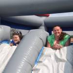 Jordan Tackett, left, and Nikki Marcano, right take a break from the bounce house to pose for a photo during the 2019 Disability Pride Celebration in Soldotna Creek Park on July 20, 2019. (Photo by Brian Mazurek/Peninsula Clarion)