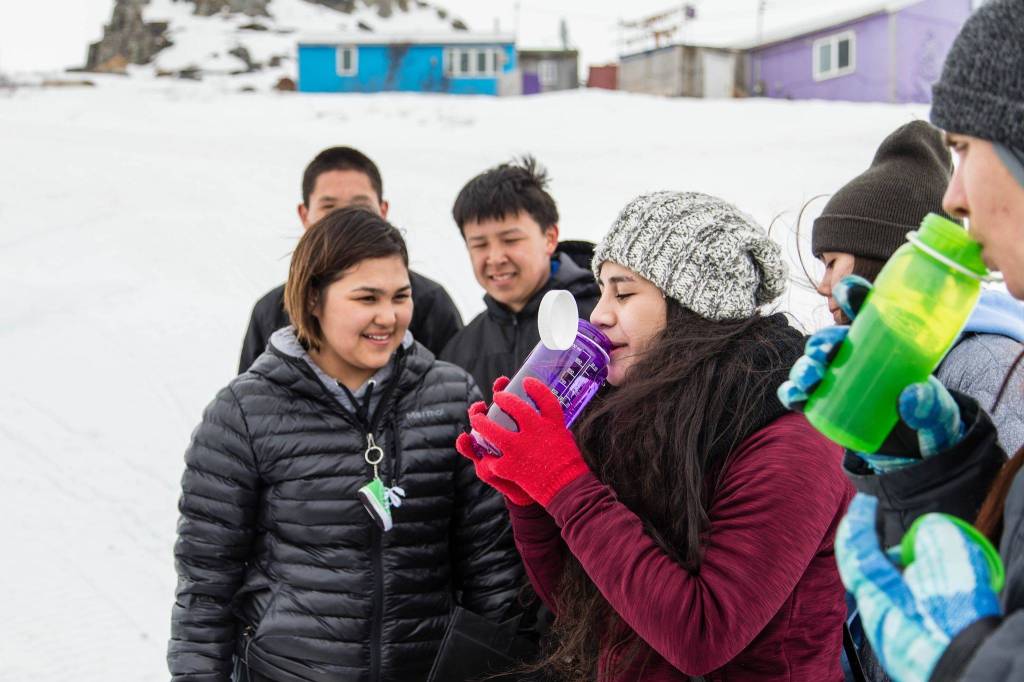 East Anchorage High School senior Nuulau Alaelua samples the stream water from her water bottle.