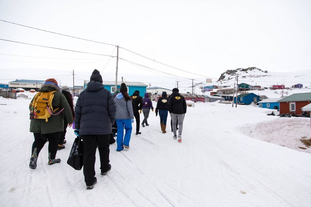 Students from East Anchorage High School get a tour of the village from their Scammon Bay School peers.