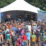 Music lovers listen to a performance on the River Stage at Salmonfest on Saturday, Aug. 4, 2018 in Ninilchik, Alaska. (Photo by Megan Pacer/Homer News)
