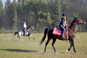 Maya Johnson, the Kenai polocrosse organizer, rides her horse during a game of polocrosse, a sport combining rules of polo and lacrosse, Thursday, July, 25, 2019 near Soldotna, Alaska. (Photo by Victoria Petersen/Peninsula Clarion)