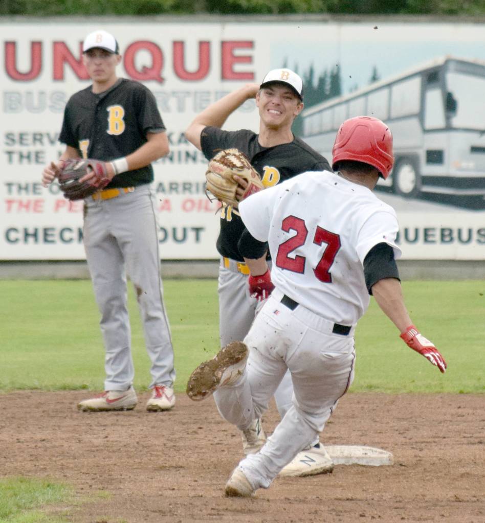 Anchorage Bucs second baseman Spencer Long turns a double play in front of Peninsula Oilers Jonathan Villa on Friday at Coral Seymour Memorial Park in Kenai. (Photo by Jeff Helminiak/Peninsula Clarion)