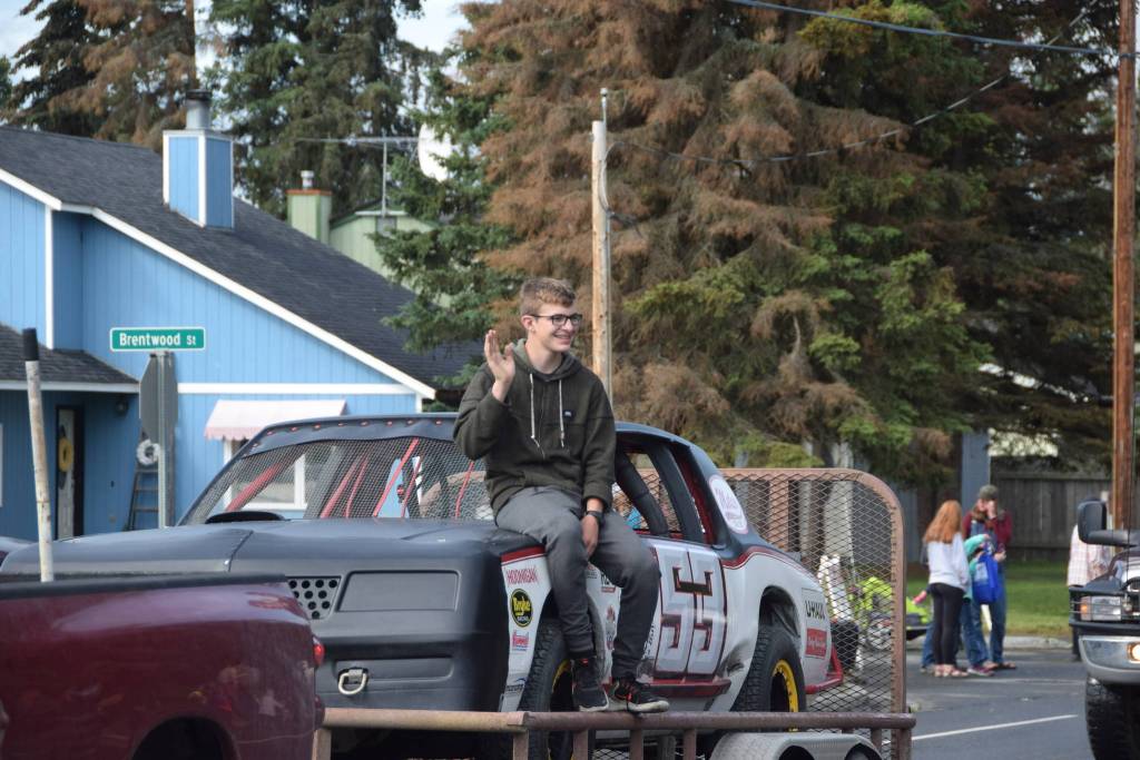 A volunteer from Twin City Raceway waves to the crowd during Soldotnas Progress Day Parade in Soldotna, Alaska on July 27, 2019. (Photo by Brian Mazurek/Peninsula Clarion)