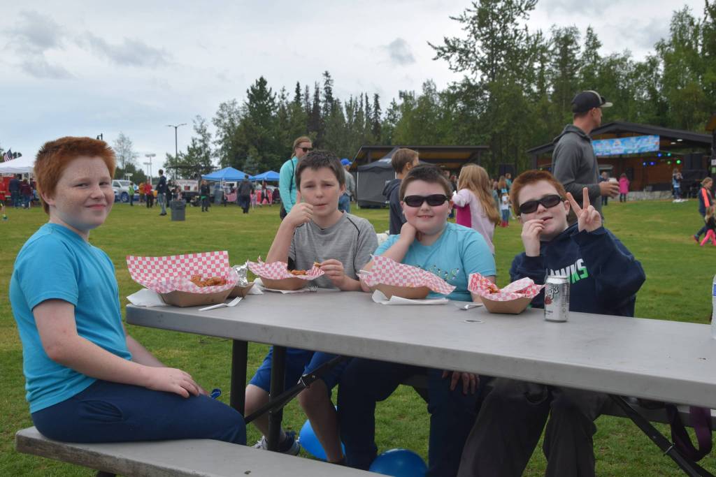 From left, Gary McVey, Ryan McVey, Carter McVey and Ben McVey smile for the camera during Soldotnas Progress Day Parade in Soldotna, Alaska on July 27, 2019. (Photo by Brian Mazurek/Peninsula Clarion)