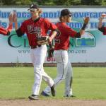 Victor Carlino, Drew Thorpe, Skyler Messinger and Paul Steffensen celebrate the Peninsula Oilers victory over the Anchorage Bucs on Sunday, July 28, 2019, at Coral Seymour Memorial Park in Kenai, Alaska. (Photo by Jeff Helminiak/Peninsula Clarion)