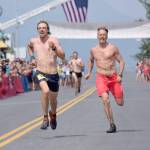 Pyper Dixon and Erik Johnson, both of Seward, sprint for the finish of the Mount Marathon Race on Thursday, July 4, 2019, in Seward, Alaska. (Photo by Jeff Helminiak/Peninsula Clarion)