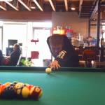 Brian Mazurek / Peninsula Clarion                                Brock Van Eaton lines up his shot on July 24 at the Compass in Nikiski, Alaska.