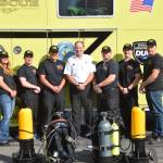 The Nikiski Fire Departments dive team poses for a photo at the Nikiski Fire Station #1 in Nikiski, Alaska on July 29, 2019. From left: Angie Smith, TJ Cox, Kassidy Stock, Bryan Crisp, Stephen Robertson, Tyler Smith and Matt Quiner. Not present: Kole McCaughey. (Photo by Brian Mazurek/Peninsula Clarion)